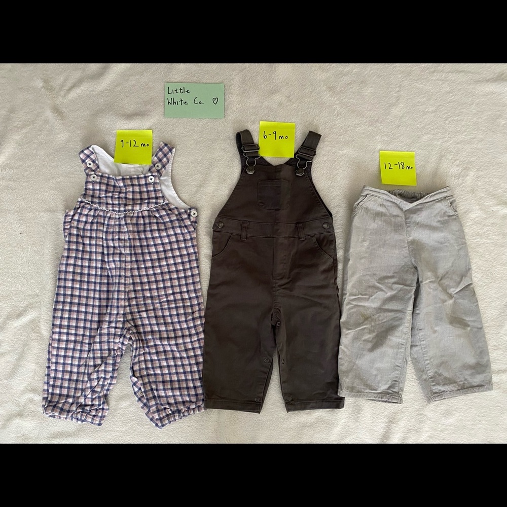 Little white company overalls and lined pants, varied sizes and prices.